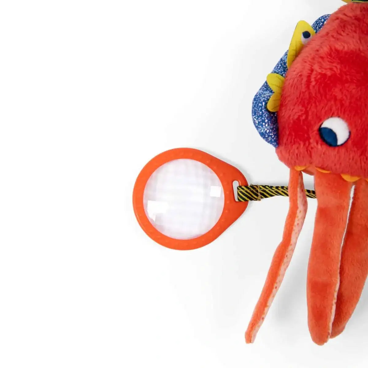 Rotes Plüsch-Oktopus-Spielzeug mit orangefarbener Lupe für Kinder